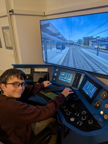 Účastníci železničního kroužku při práci se simulátory a železniční technikou